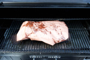Wrapping the smoked brisket in paper and continuing the smoke.