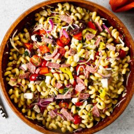 A closeup of Italian pasta salad with smoked vegetables and salami.