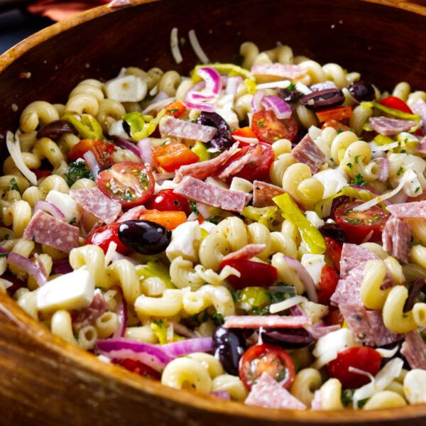 A close up of smoked pasta salad with salami and mozzarella.