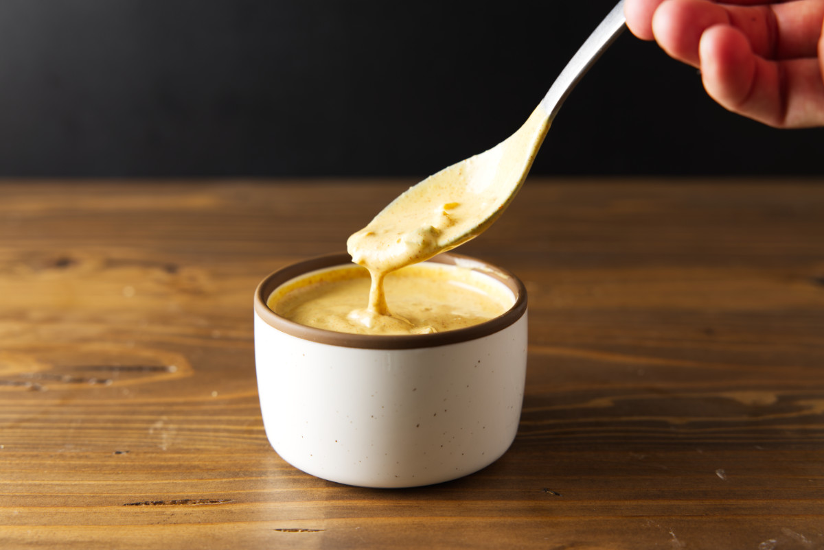 Smash burger sauce in a bowl with a spoon scooping out some.