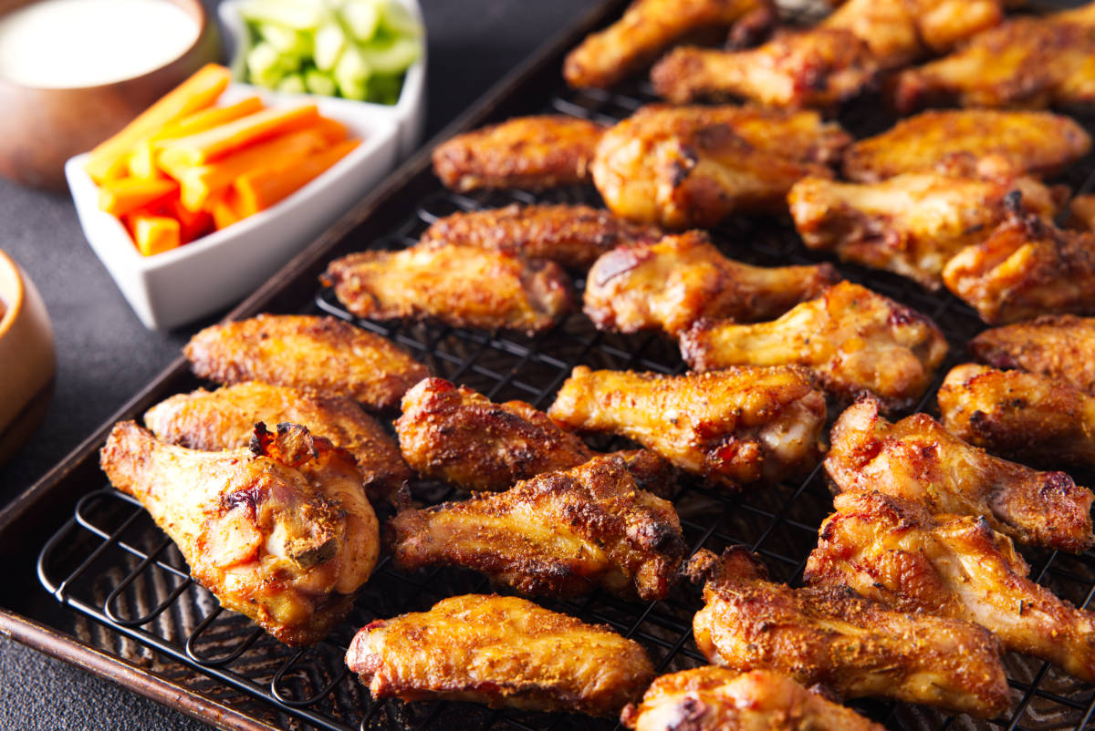Close up of the well seasoned smoked chicken wings on a wire rack.