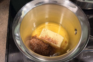 Melting butter with barbecue seasoning for smoked corn on the cob.