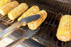 Turning on the pellet grill to preheat for smoked corn on the cob.